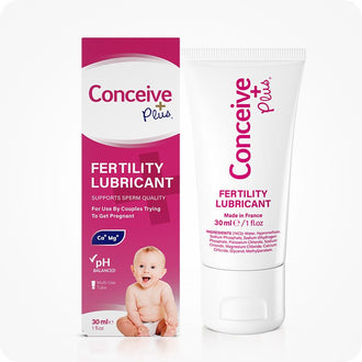 Conceive Plus Fertility Lubricant (1fl.oz/30ml Tube) displayed with its retail box showing product branding, a pink and white color scheme, baby image, and visible details like pH balanced, Ca+ and Mg+ ions support for conception.