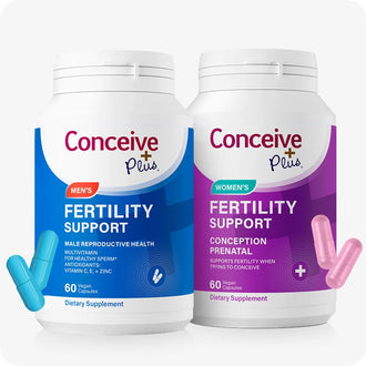 Conceive Plus Fertility Support Bundle for Him and Her, showing two white bottles—one with a bold blue label for men's fertility support and other in purple for women’s fertility support health—placed side by side with matching blue and pink capsules displayed near base.
