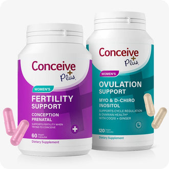 Conceive Plus Women's Fertility Support and Ovulation Support Bundle featuring two supplement bottles—one in purple labeled “Women's Fertility Support” and other in teal labeled “Women's Ovulation Support”—with pink and beige capsules floating beside them, all displayed on white background to show product branding and capsule appearance for improved accessibility.
