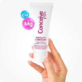 For Conceive Plus Max Combo - Fertility Lubricant Bundle, image highlighting a 75ml fertility lubricant tube held upright between two fingers, with calcium and magnesium ion graphics floating beside it to emphasize mineral-enriched formulation for improved sperm viability and conception support.