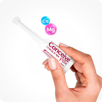 For Conceive Plus Max Combo - Fertility Lubricant Bundle, featuring a single 4g pre-filled fertility lubricant applicator held between two fingers, with floating calcium and magnesium ion icons in background highlighting fertility-enhancing formula designed for easy vaginal application.