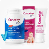 Conceive Plus Men's Fertility Support and Fertility Lubricant Bundle showing a 60-capsule blue bottle of Men's fertility support supplements and two loose capsules, a box of 30ml fertility lubricant support with baby image, and a 30ml fertility lubricant tube—all upright and front-facing against a white background.